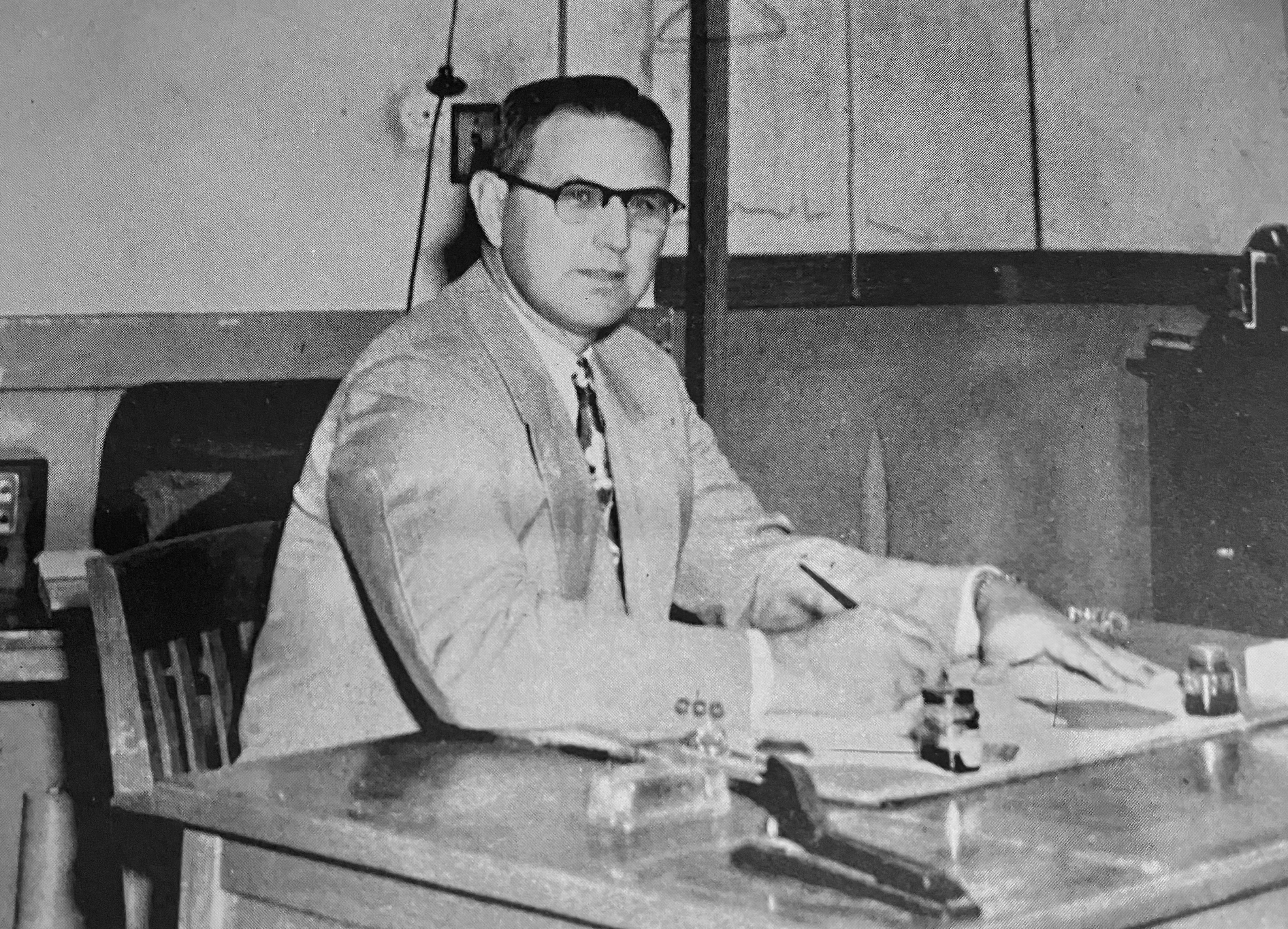 Principal Romain Picard At His Desk - Maurice High School